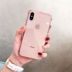 a woman holding an iphone in her hand with the case on it's side