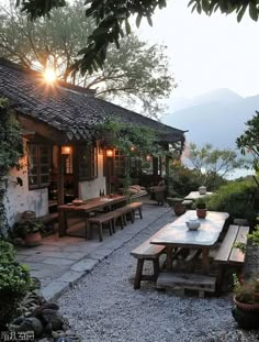 an outdoor dining area with wooden tables and benches