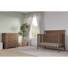 a baby's room with a crib, dresser and bed