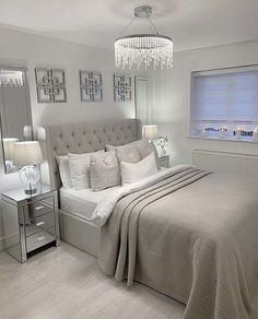 a bedroom with a large bed and chandelier