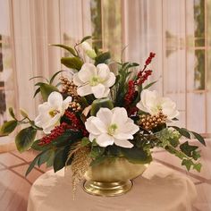 a vase filled with white flowers on top of a table