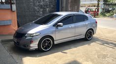 a silver car parked in front of a building