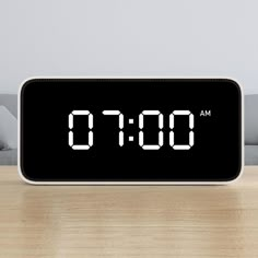 an alarm clock sitting on top of a wooden table