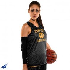 a woman holding a basketball in her right hand and wearing a black jersey with the golden state warriors on it