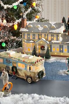 a christmas scene with an rv and people in the snow