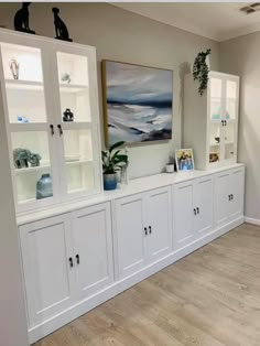 a room filled with white cabinets and lots of glass doors on top of each cabinet