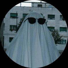 a ghost with sunglasses on it's head is standing in front of a building