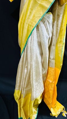 Bringing you the finest collection of Banarasi Tissue Silk Sarees yet another stylish , elegant and timeless piece from our master weavers in Banaras. Adorn this Kanchipuram inspired tissue silk saree in gold zari with floral jaal all over. With double border on the bottom and contrast color pallu this piece is gorgeous to the core and timeless . Luxurious fabric with softness and sheen just remarkable. Photos don't do justice .. this saree is just... glamorous Comes with fall/ Pico / tassels and a stitched blouse. Blouse Detail: Stitched blouse size 38, upto 42. front closure and padded with elbow level sleeves. Saree comes in a beautiful saree cotton bag. Note: Colors that show up on your screen may vary slightly from the actual product due to variations in settings. Also, the actual pro Festive Yellow Raw Silk Pre-draped Saree, Gold Tussar Silk Pre-draped Saree With Pallu, Yellow Silk Pre-draped Saree With Pallu, Transitional Gold Banarasi Silk Pre-draped Saree, Gold Tussar Silk Pre-draped Saree With Zari Weaving, Yellow Katan Silk Pre-draped Saree, Gold Anarkali Banarasi Silk Pre-draped Saree, Gold Handloom Pre-draped Saree For Wedding, Traditional Yellow Raw Silk Pre-draped Saree