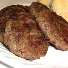 three hamburger patties on a white plate