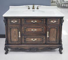 an antique bathroom vanity with white marble top