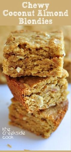 three pieces of chewy coconut almond blond blondies stacked on top of each other