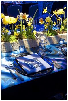 a table set with blue plates and silverware