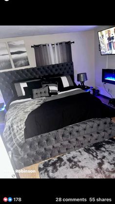 a bed room with a neatly made bed and a flat screen tv on the wall