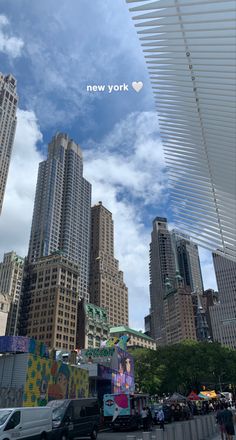 there are many tall buildings in the city and one has a heart shaped sign above it