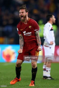 a soccer player reacts to his team's goal during the match between two teams