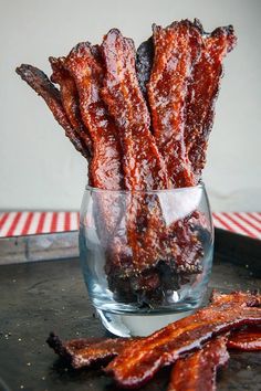 bacon sticks in a glass bowl on a tray