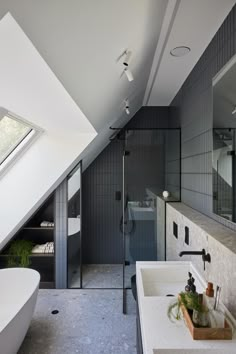 a bathroom with a skylight, sink and bathtub in the middle of it