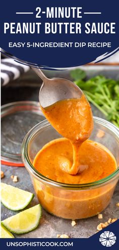 a spoon full of sauce being lifted from a glass bowl with limes and cilantro on the side