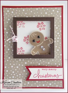 a handmade christmas card with a ginger on the front and a red ribbon around it