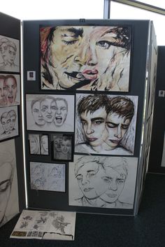 a group of drawings on display in a room