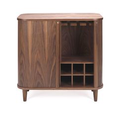 Featuring sliding tambour doors disappearing on the side, this cabinet opens to a spacious repository for spirits, bar tools, and supplies. Its mid-century silhouette complements the Natural Walnut grain. This simple yet elegant storage solution is equipped with hanging brackets for stemware and a lower rack that fits 12 bottles. Dimensions Overall 31.5"W x 31.25"H x 17.5"D (83.78 lbs) Leg 5.75"H Inside 12"W x 13.25"H x 13.5"D Bottle Storage 4"W x 4"H x 13.5"D Stemware Storage Rack 1.25"W  Walnu Tambour Doors, Stemware Storage, Wine Cabinet, Global Views, Bottle Storage, Wood Polish, Natural Walnut, Wine Cabinets, Walnut Veneer