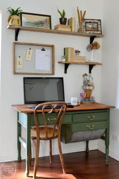 a desk with a laptop computer on top of it next to shelves filled with office supplies