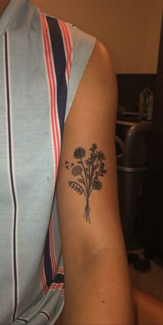 a person with a flower tattoo on their arm