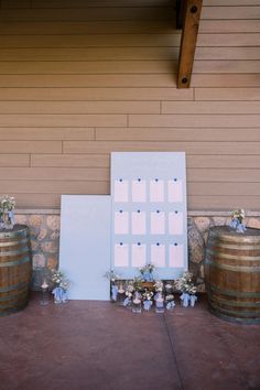 an outdoor ceremony with wine barrels and flowers