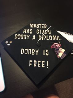 a black graduation cap that says master has given dobby a diploma, dobby is free