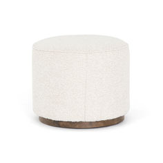 a small white ottoman with wood base