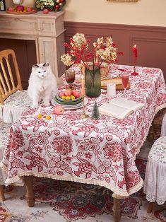 a white cat sitting on top of a table