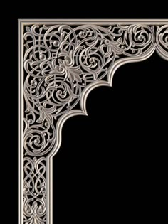 an intricately designed metal frame on a black background