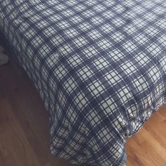 there is a bed with a blue and white checkered comforter on top of it