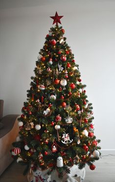 a decorated christmas tree with red and white ornaments