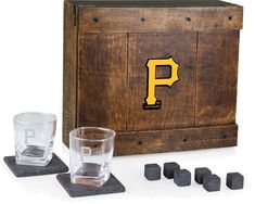 a wooden box with four glasses and one shot glass in front of it on top of coasters