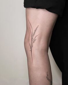 a woman's lower body with a tattoo on her thigh and the bottom part of her leg