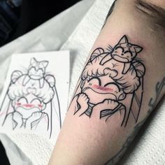 a person with a cat tattoo on their arm