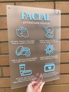 a hand is pointing at a sign with instructions on how to use facial aftercare advice