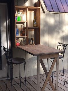 a wooden table sitting on top of a wooden deck