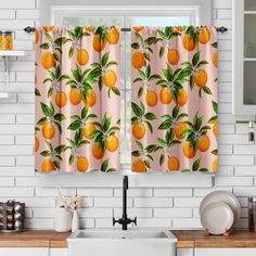 a kitchen window curtain with oranges on it