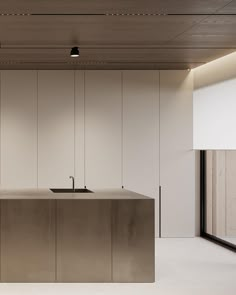 an empty kitchen with stainless steel counter tops