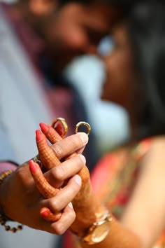 a man and woman holding hands with rings on their fingers