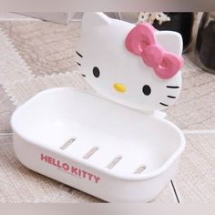 a hello kitty soap dish on the floor