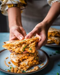 a person is grabbing some food from a plate