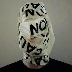 a man wearing a mask made out of letters