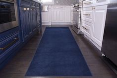 a blue rug is in the middle of a kitchen