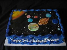 a birthday cake with an image of the solar system on it