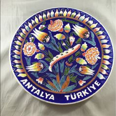 a blue plate with flowers and the words antalyya turkiye on it