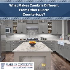 a large kitchen with marble counter tops and gray cabinets is featured in the article, what makes cambia different from other quartz countertops?