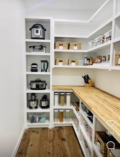 an organized pantry with wooden counter tops and shelves